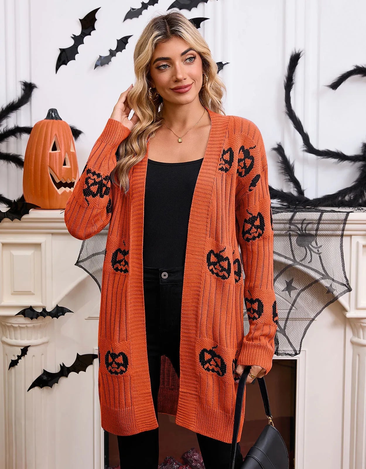 Women's black Halloween cardigan with orange Jacquard pumpkin head pattern on the front.