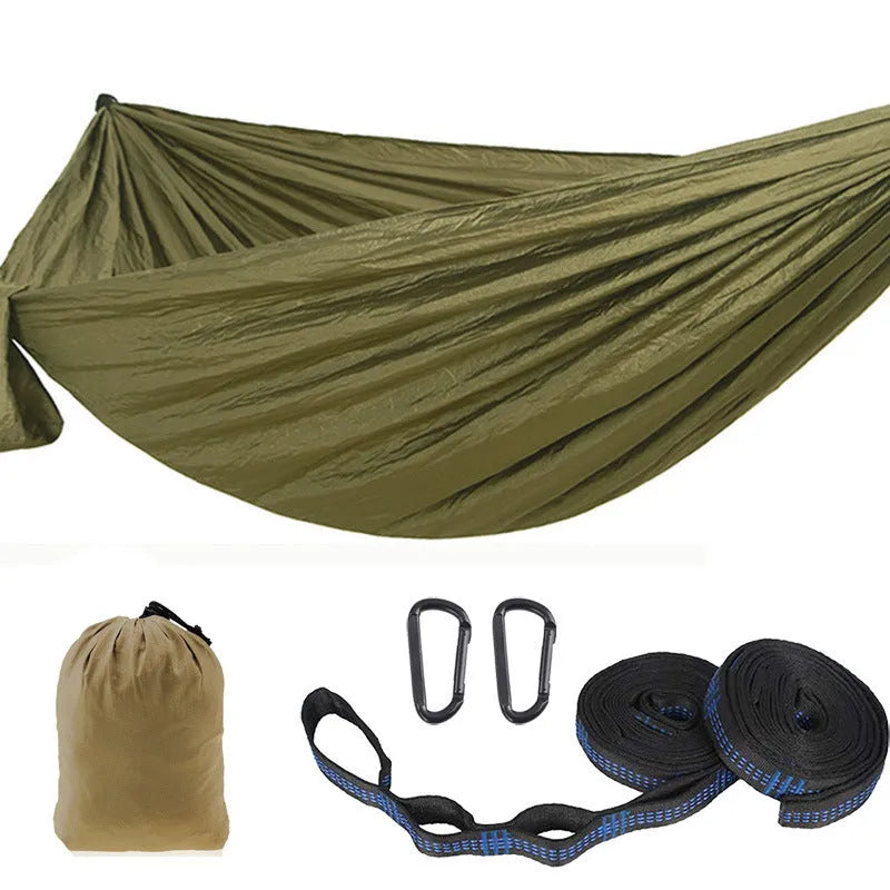 Double camping hammock with ropes and buckles shown in outdoor setting