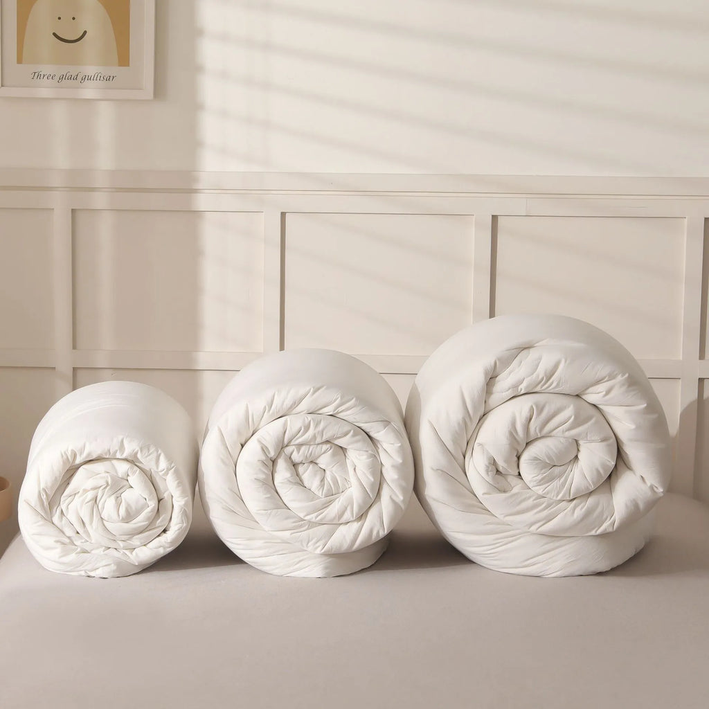 Soybean fibre quilt with pure cotton cover in grey colour on a bed.
