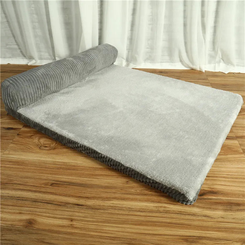 Corduroy bolster dog bed in grey, showing bilateral raised sides and non-slip base.