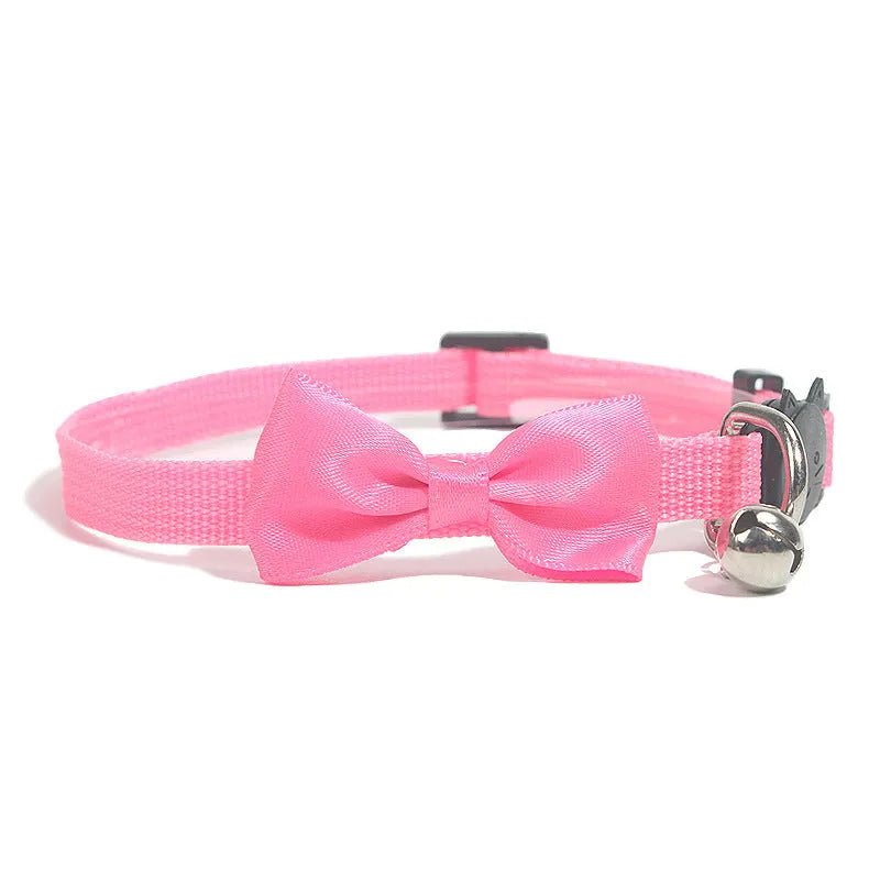 Adjustable striped nylon cat collar with a bell shown in multiple colours including red, blue, green, and pink.