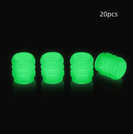 Pack of green and blue luminous rubber tyre valve caps on a car tyre valve.