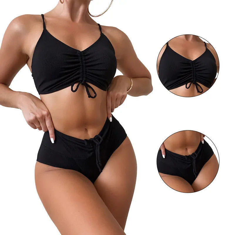 Black high-waisted bikini swimsuit for women with sleeveless top and shorts on a neutral background.