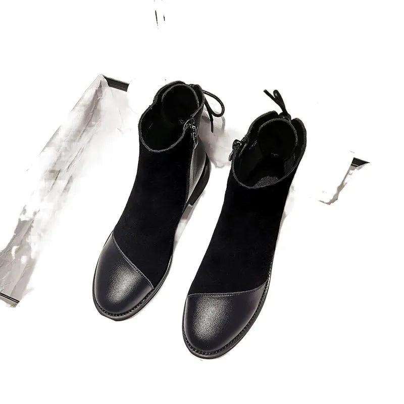 Black women's knee-high martin boots with a side zipper, round toe, and decorative bow.