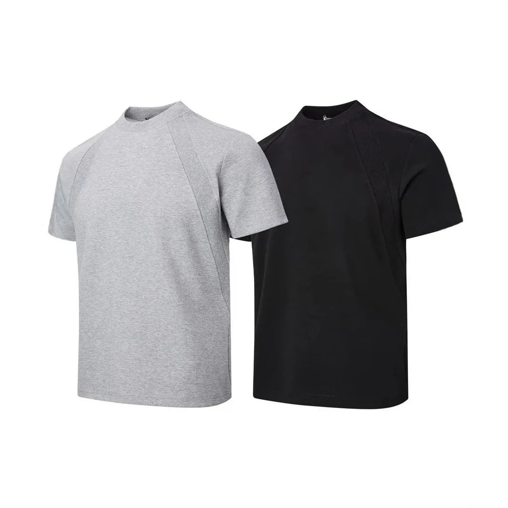 Man wearing a loose-fit grey short sleeve polyester top with air layer stitching.