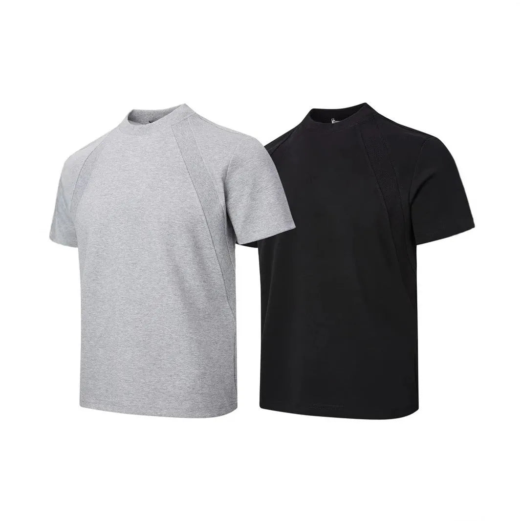 Man wearing a loose-fit grey short sleeve polyester top with air layer stitching.