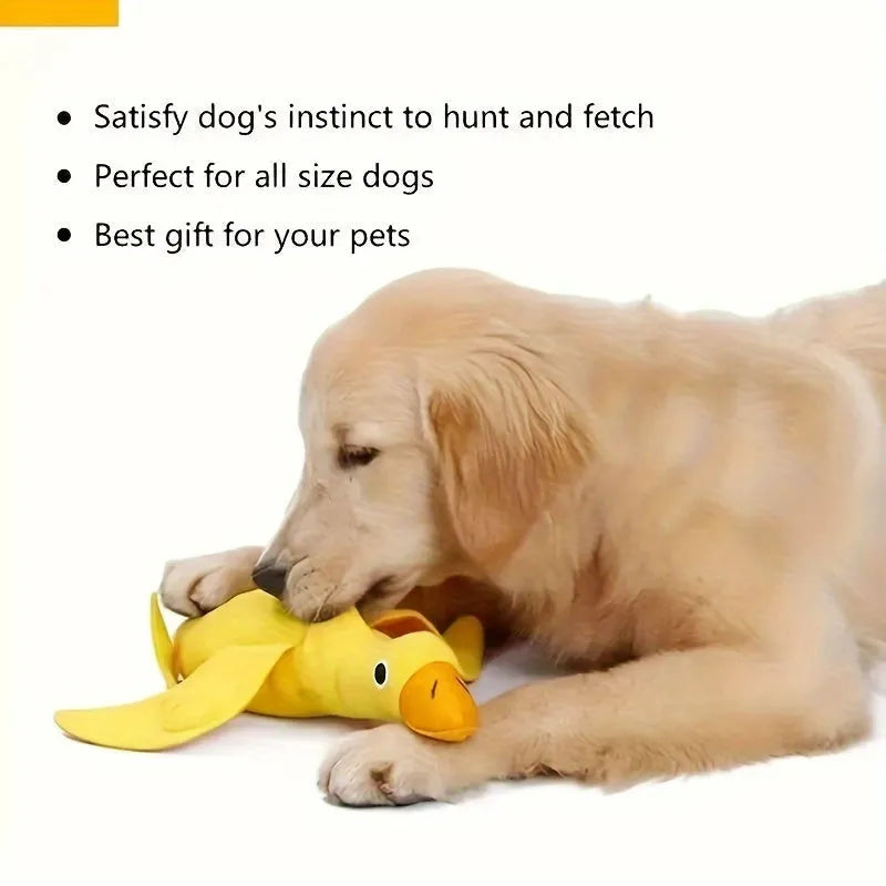 Yellow plush teddy bear dog toy with a small duck doll attached, showing food dispensing holes.