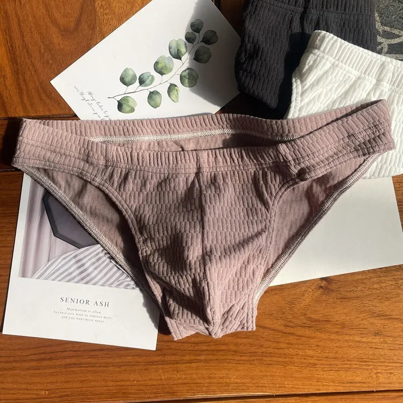 Men's solid colour cotton triangle briefs in mid-waist style, shown in apricot and black colour options.