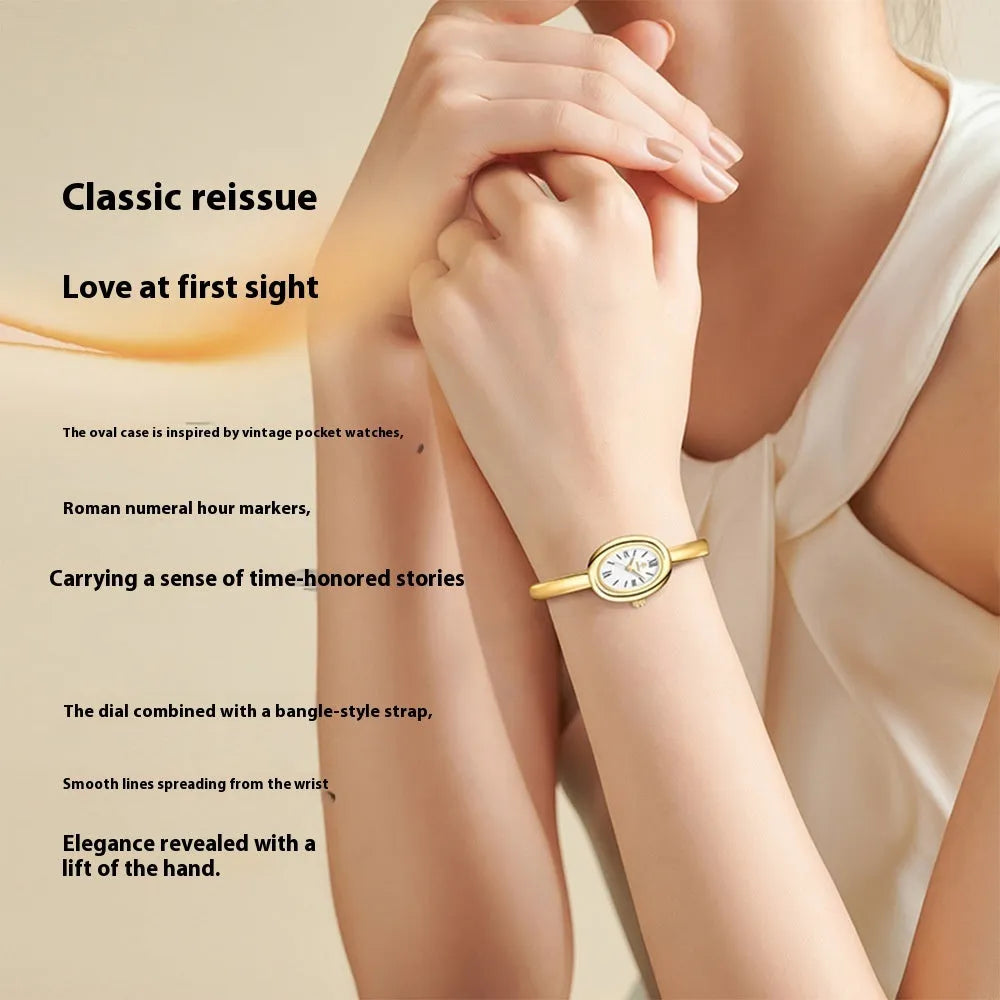 Women's slim oval retro quartz watch in gold colour on wrist