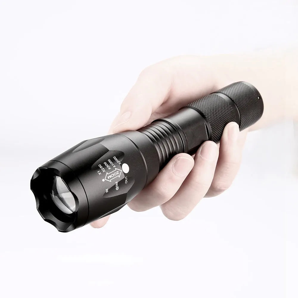 Black aluminium alloy zoomable LED flashlight with adjustable focus head for outdoor use.