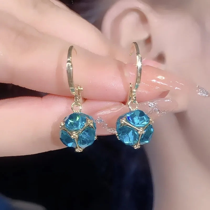 A pair of women's geometric copper earrings with a rose design and small zircon stone accents.