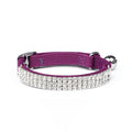 Adjustable red velvet cat collar with rhinestone details on a suede strip.