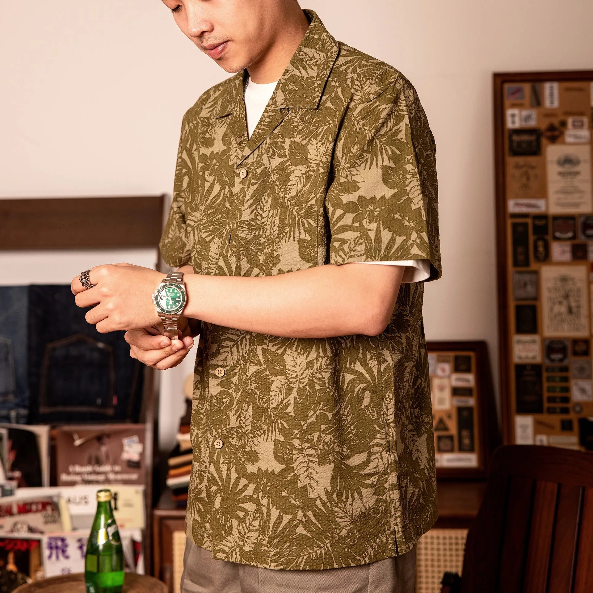 Man wearing a green vintage floral print seersucker shirt with a Cuban collar.