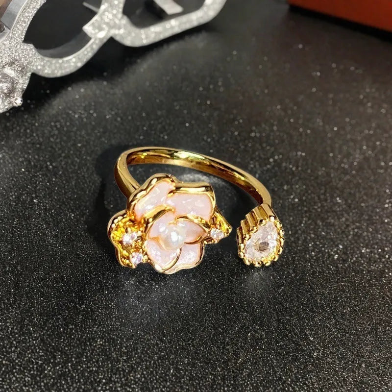 Adjustable Chinese gourd ring with zircon inlay showing floral and bow elements in oil-drip finish