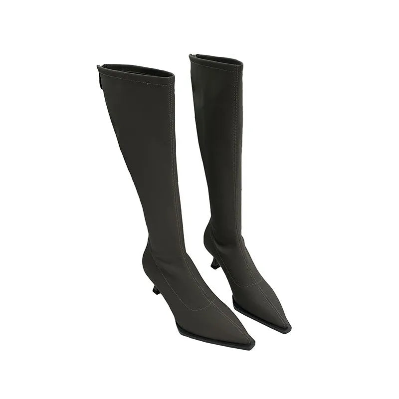 Black pointed toe women's below-the-knee boots with stiletto heel and back zipper fastening.