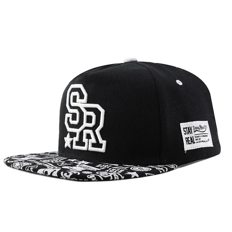 Cotton baseball cap with embroidered letters on the front, shown in black and white colours.
