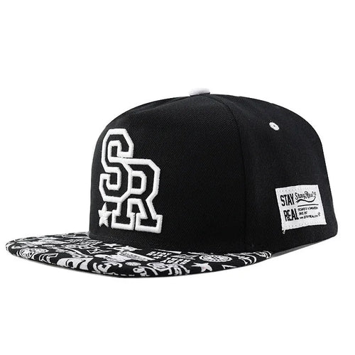 Cotton baseball cap with embroidered letters on the front, shown in black and white colours.