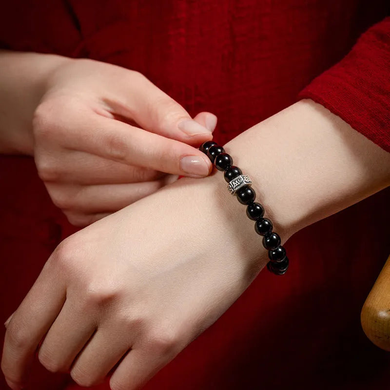 Obsidian zodiac bracelet with 8mm beads showing carved animal and bodhisattva designs in Chinese ethnic style