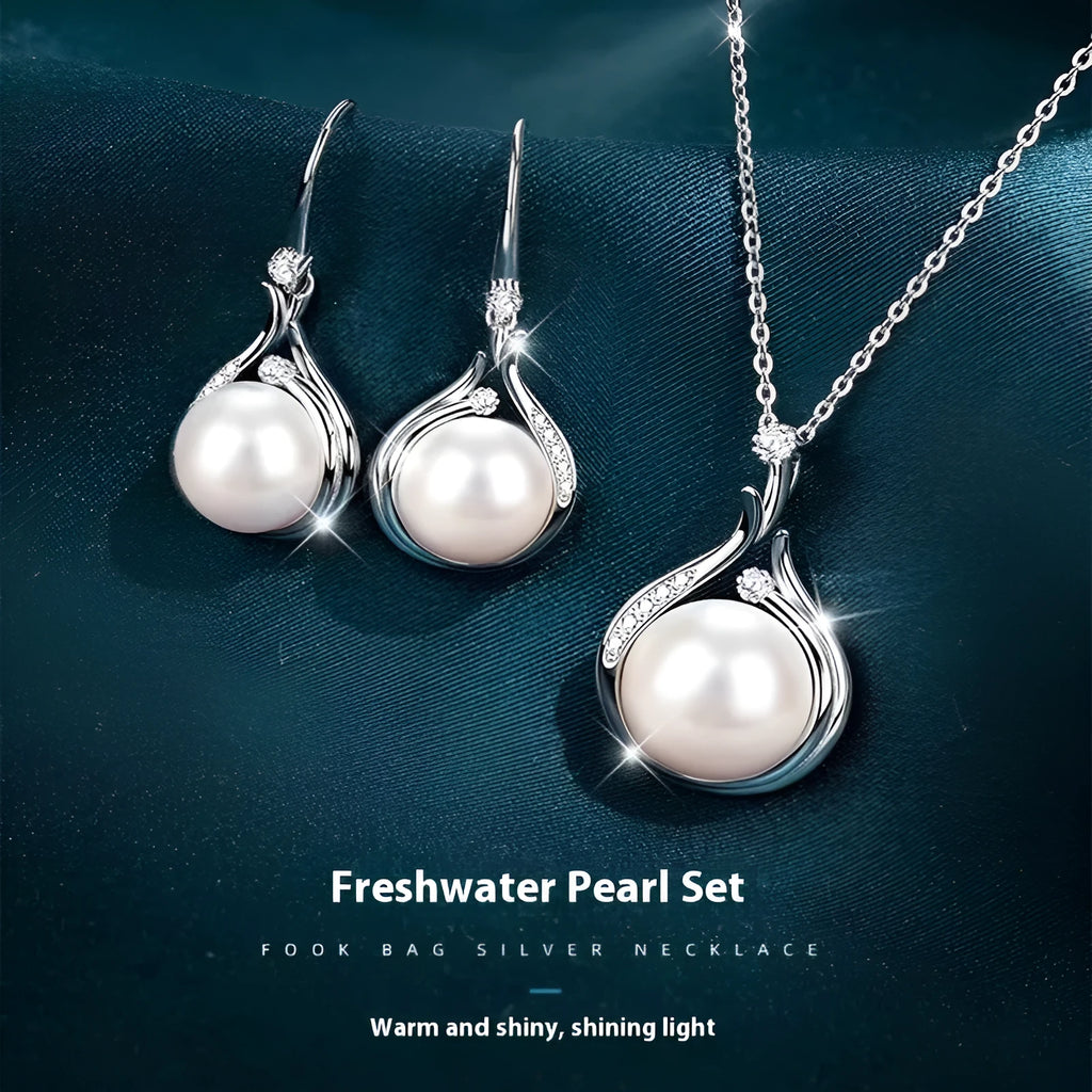 S925 silver necklace with natural freshwater pearl and geometric mother-of-pearl pendant on cross chain over a knitted sweater