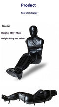 Black patent leather bondage restraint kit with body wrap and six ratchet tie down straps