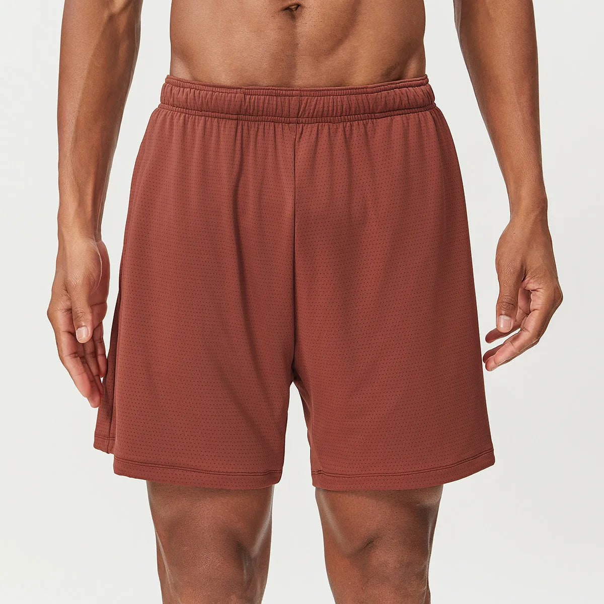 Men's double-layer quick-drying running shorts in brick red colour on a mid-waist model.