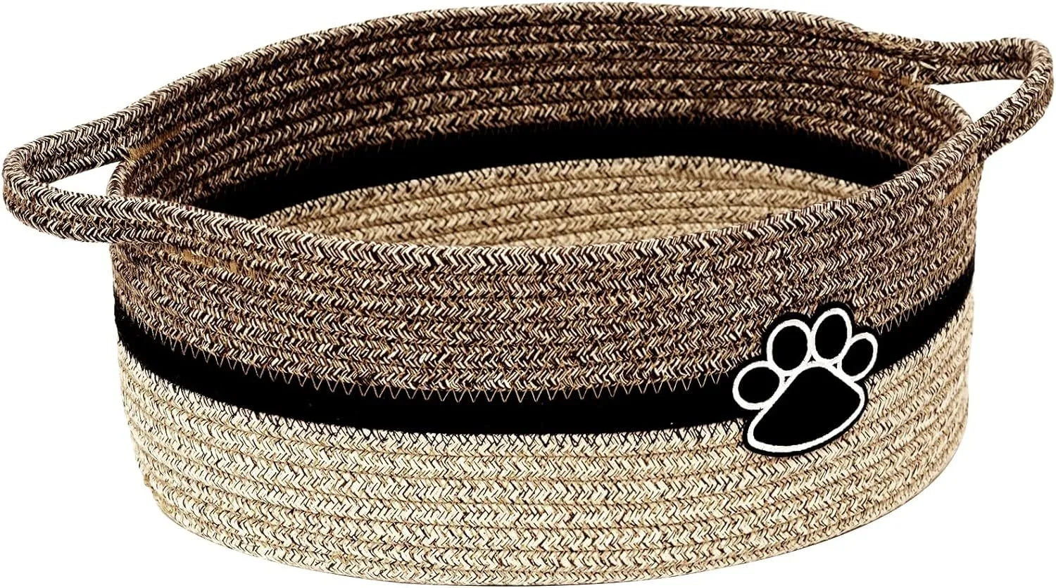 Light beige handmade woven cotton rope storage basket with handle on a wooden surface.