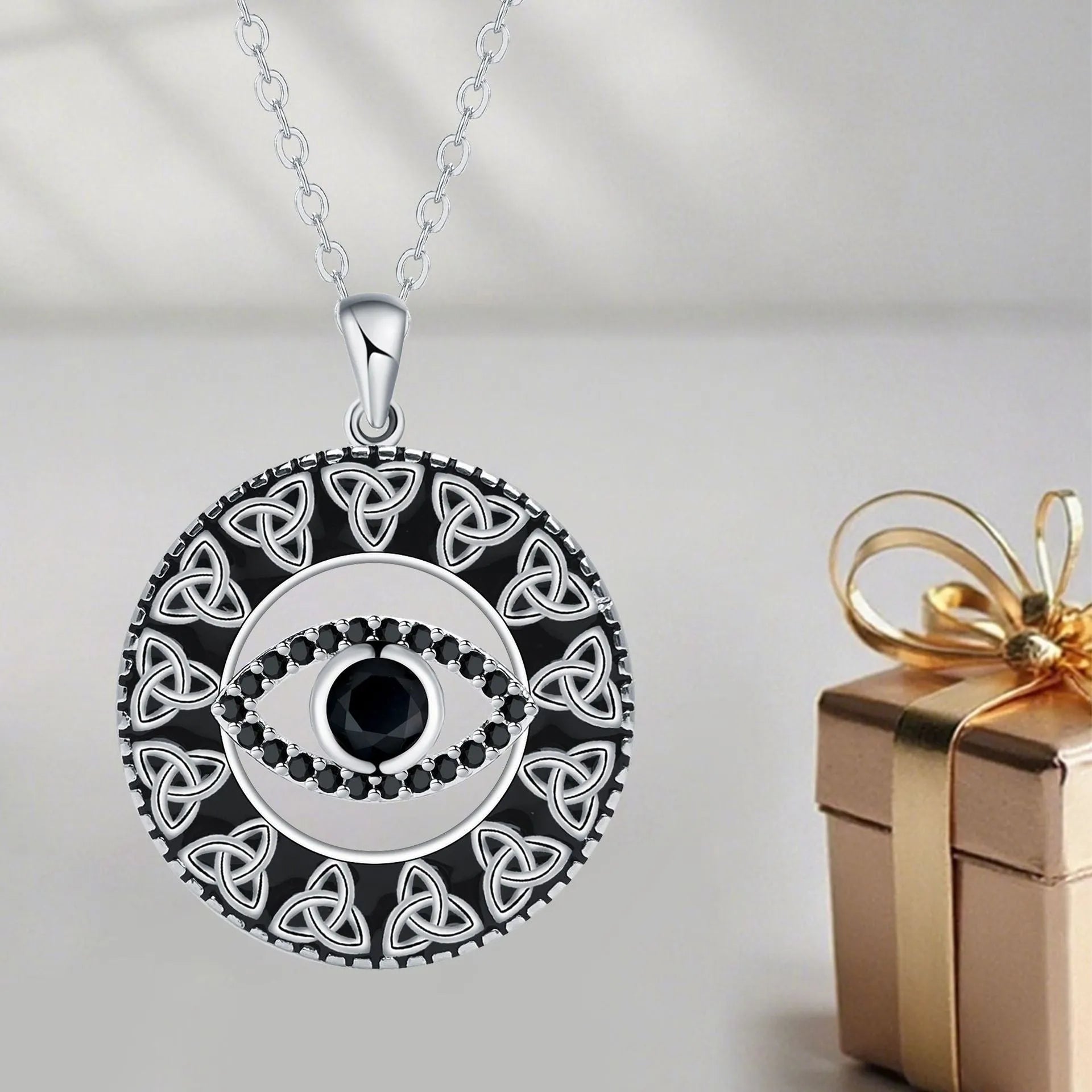 Copper Devil's Eye pendant necklace with cross chain design on display