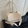 PU leather tote bag in beige with double shoulder strap and visible stitching detail.