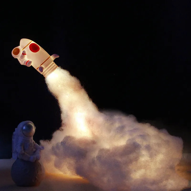 DIY astronaut rocket night light kit with LED string lights and build materials on a desktop