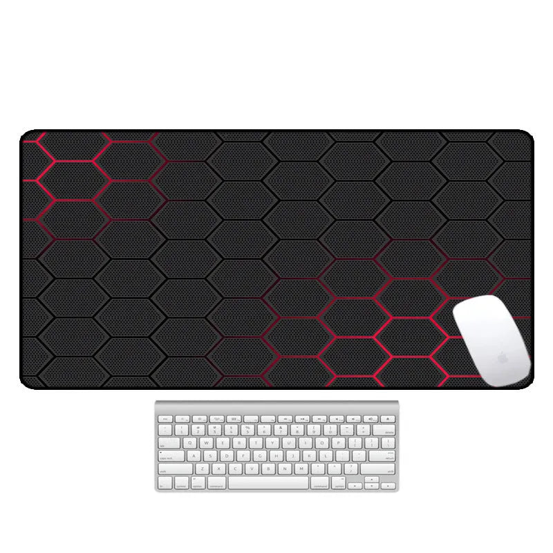 Large black rubber desk mouse pad with a printed geometric pattern, shown on a wooden desk.