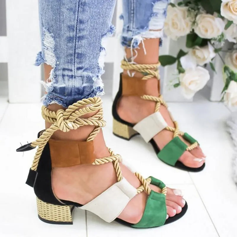 Women's beige suede sandals with fish-mouth toe, colour-matched pattern, and ankle strap on a thick heel.