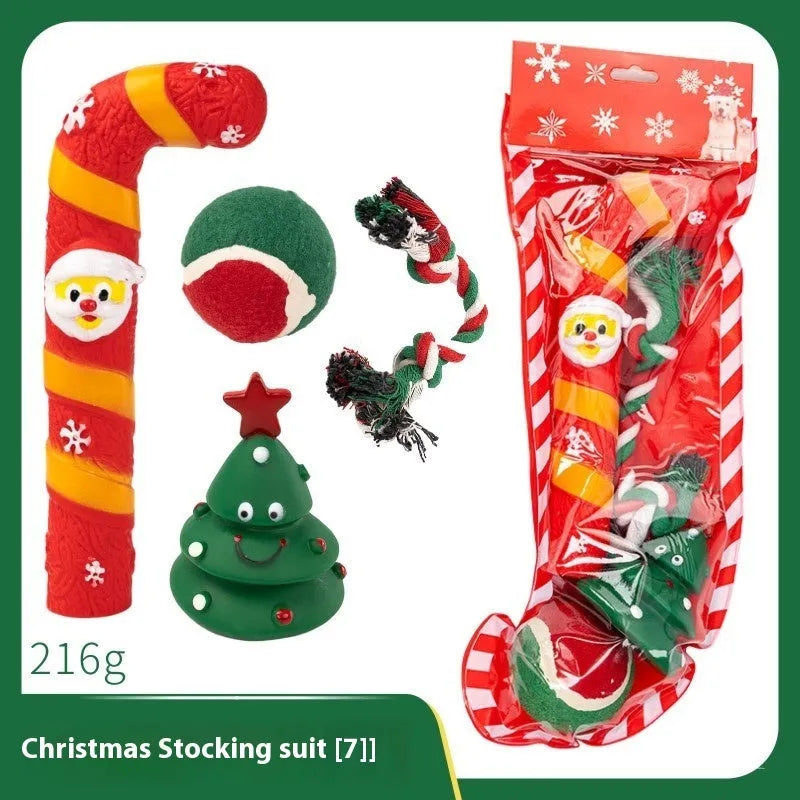 Seven Christmas gift bags containing vinyl dog toys with Santa heads, trees and deer figures