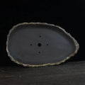 Handmade purple clay flower pot showing unique shape and natural clay texture