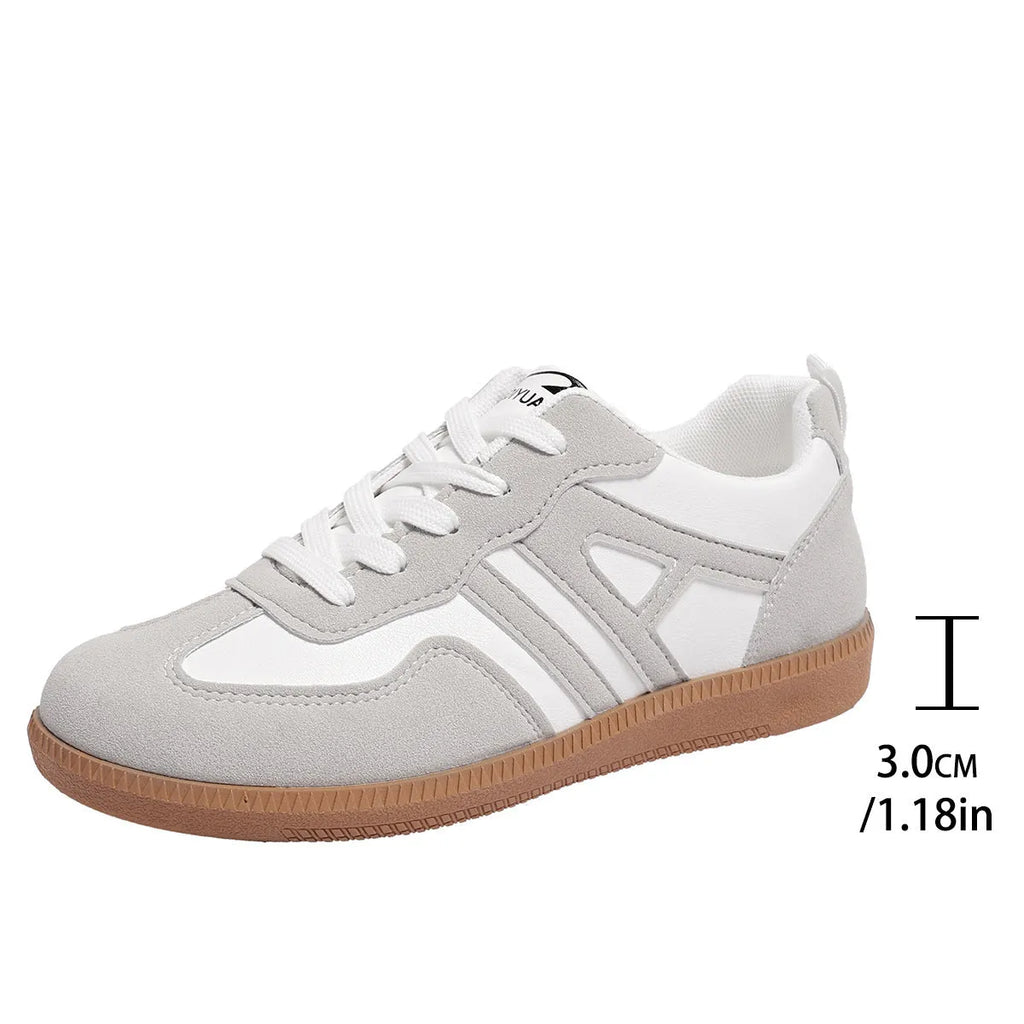 Retro women's jogging shoes in black with lace-up front, cross strap, and platform heel design