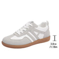 Retro women's jogging shoes in black with lace-up front, cross strap, and platform heel design