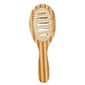 Natural bamboo scalp massage comb with round nylon teeth and rubber pad on neutral background