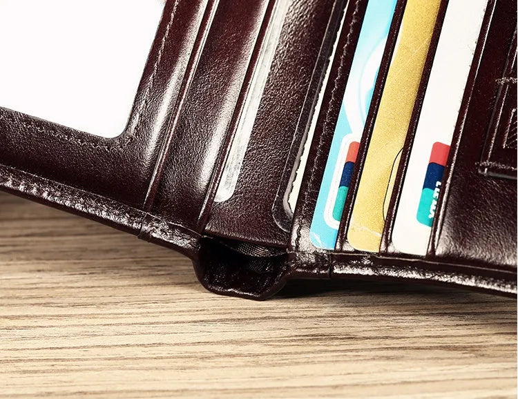 Men's black leather wallet open to show internal card slots, coin pocket, photo holder, and document section.