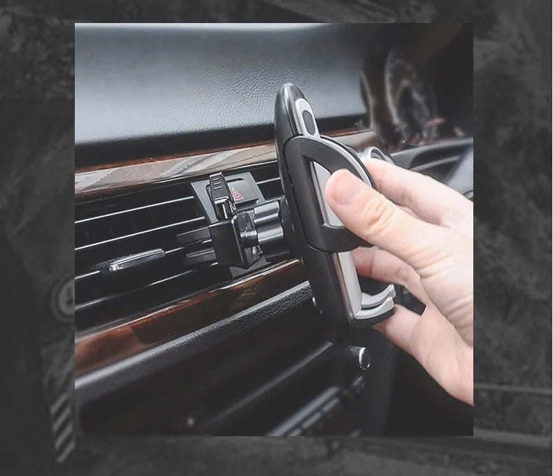 Black plastic car vent phone holder mounted on air conditioning outlet with smartphone