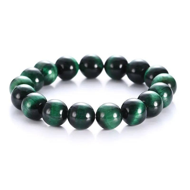 Green Tiger Eye stone beaded bracelet with geometric shaped beads on a wrist.