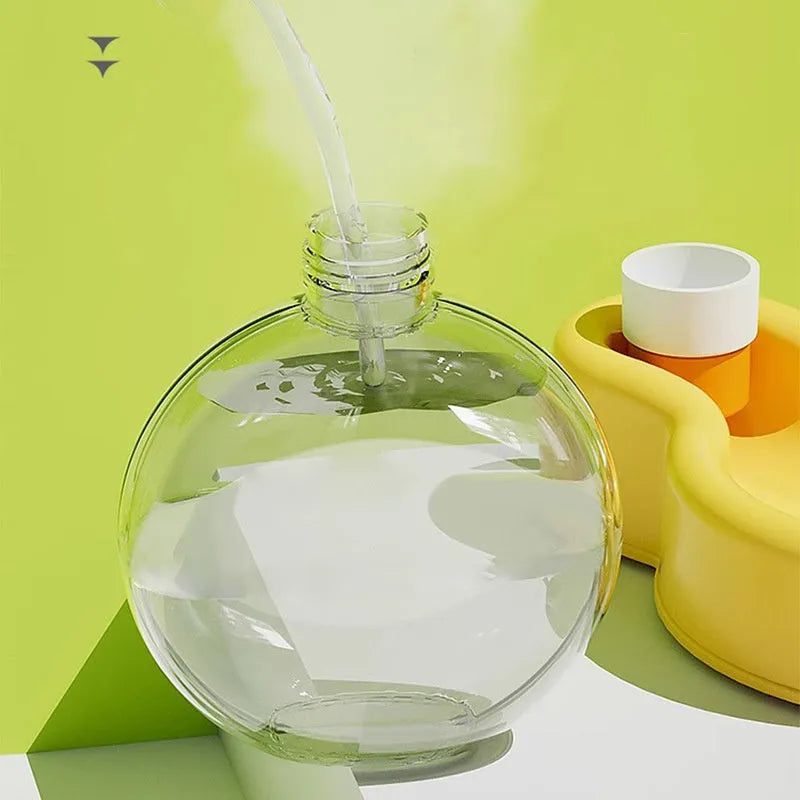 Green portable dog travel cup with integrated drinking bowl, showing 500ml capacity and pull-out bowl design.