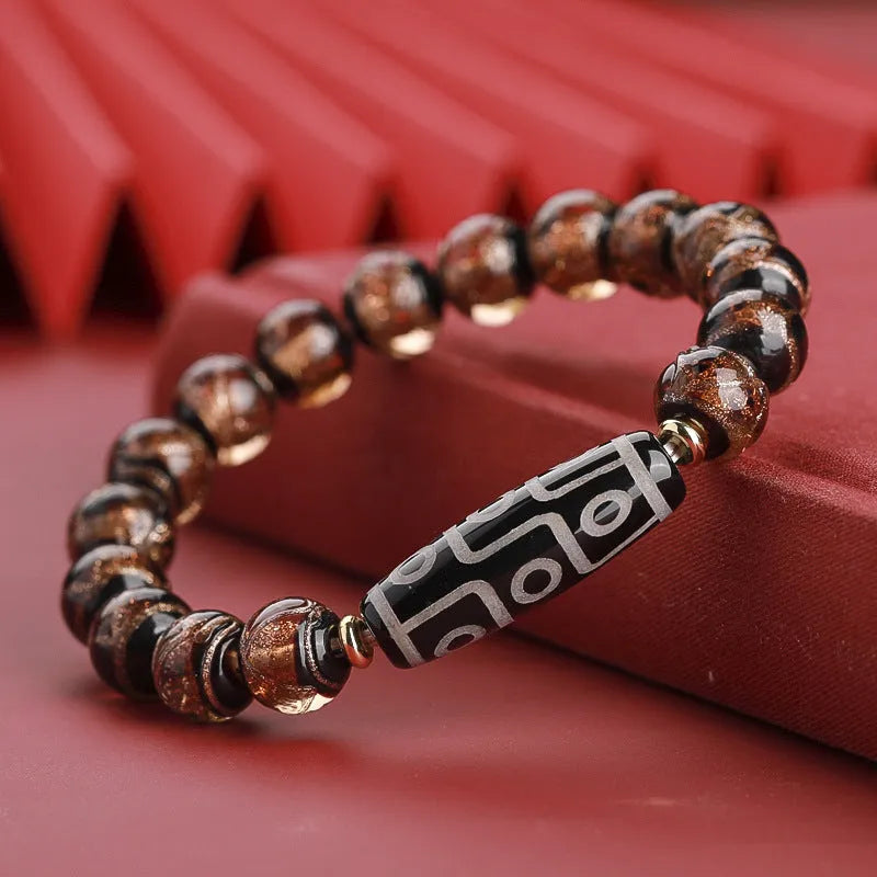 Close-up of a coloured glaze bracelet with traditional Chinese snake design and multi-coloured beads.