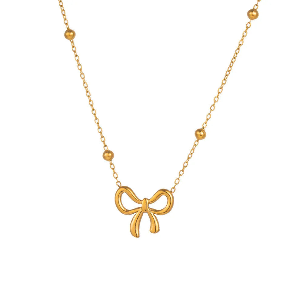 Gold electroplated bow necklace on cross chain with adjustable length
