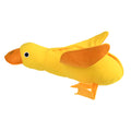 Yellow plush teddy bear dog toy with a small duck doll attached, showing food dispensing holes.