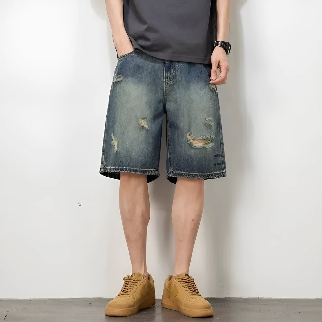 Retro blue denim men's shorts with loose hole details and straight leg.