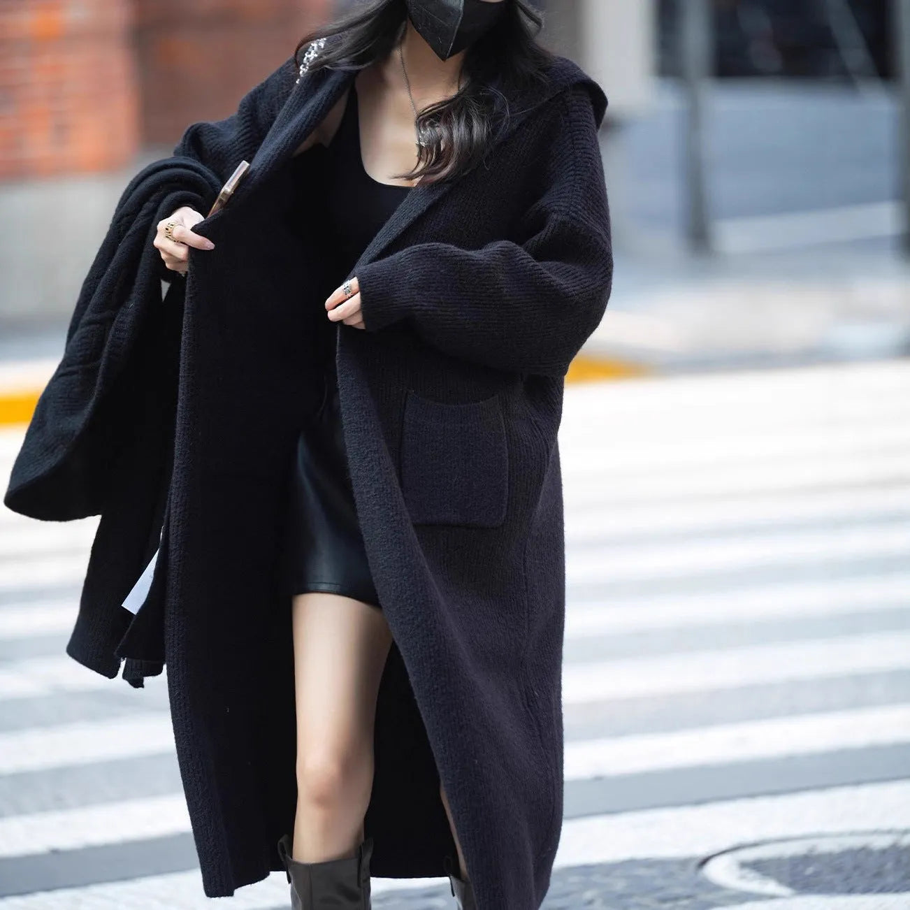 Long grey knitted hooded trench coat with a loose, cardigan-style fit and long sleeves.
