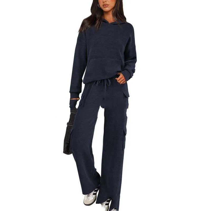 Women's two-piece leisure sports suit in polyester, showing long sleeve top and trousers in a solid colour.