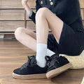 Retro black low-top sneakers with round toe, waterproof platform, and injection-moulded rubber sole