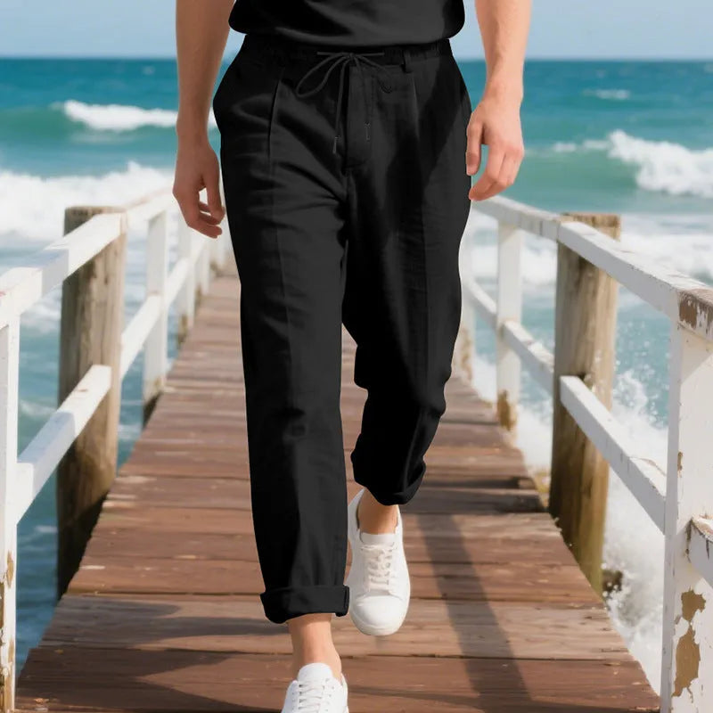 Men's light khaki linen casual trousers with a drawstring waist and straight-leg fit on a hanger.