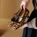 Women's black square toe stiletto ankle-strap heels with a horse hair upper and buckle fastening.