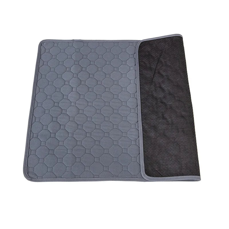 Pet Parents grey and khaki washable dog pee pads in multiple sizes on a wooden floor.